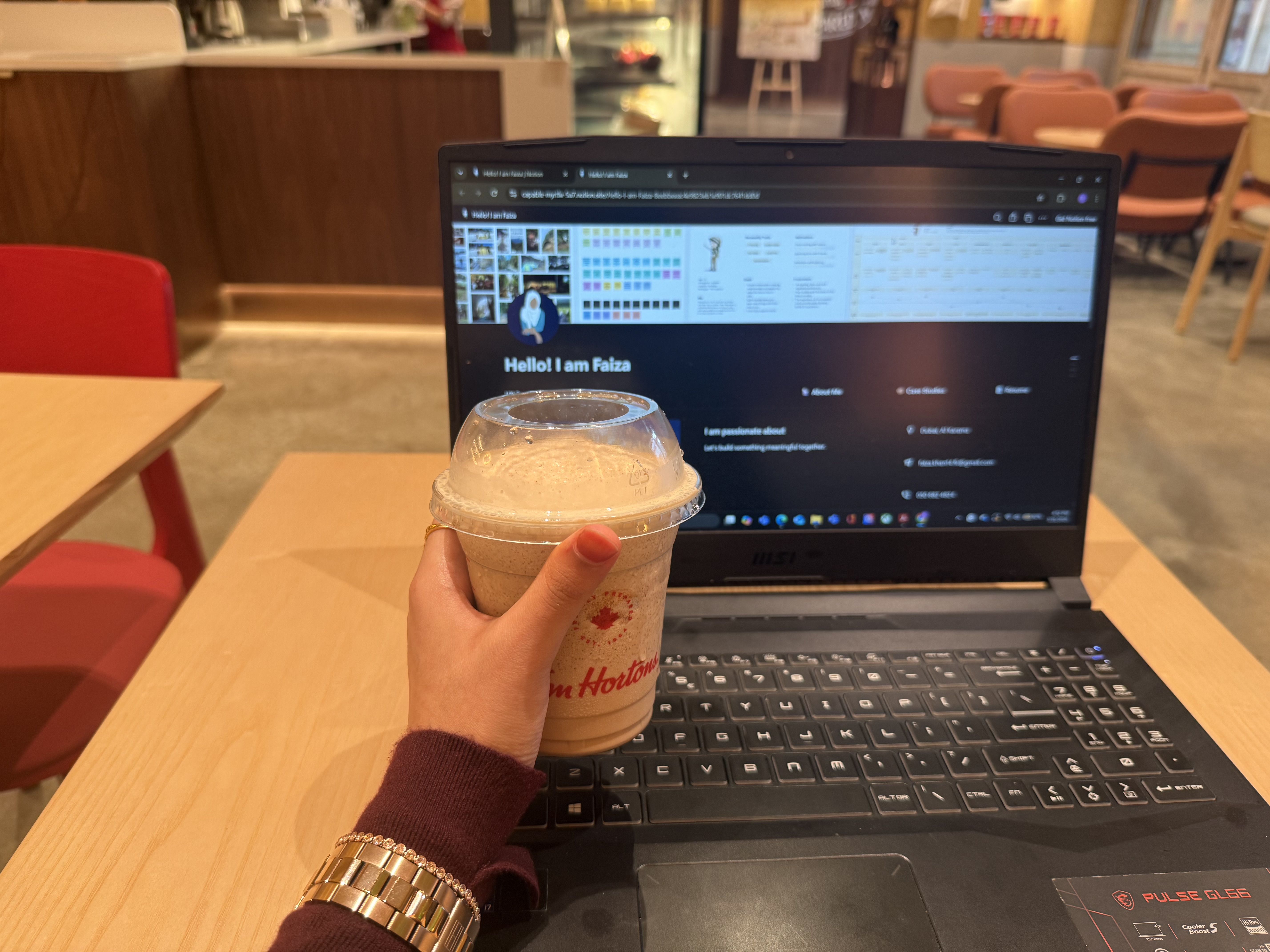 Cold coffee and laptop in a Dubai café